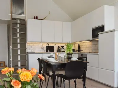 a kitchen with a table and chairs in a room at 10 person holiday home in Brattvåg in Brattvåg