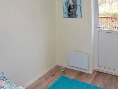 a living room with a blue rug and a window at 10 person holiday home in Brattvåg in Brattvåg