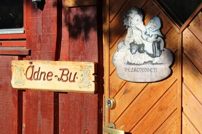 a sign on a wooden door with a woman and child at Ådnebu by Norgesbooking - cabin with 3 bedrooms in Geilo