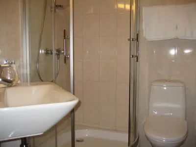 a bathroom with a sink and a toilet and a shower at Motell Nor-Kro in Bromma