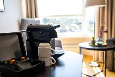 a desk with a coffee cup and auments at Scandic Kristiansund in Kristiansund