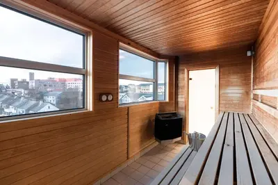 an empty room with a bench and windows at Scandic Kristiansund in Kristiansund