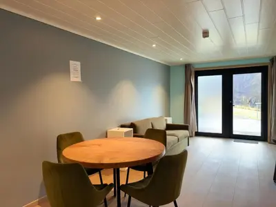 a living room with a table and chairs and a couch at Winjum Apartments Aurland Stegastein in Aurland