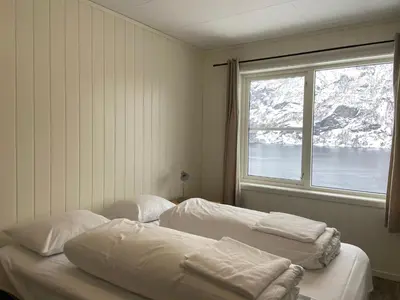 two beds in a room with a window at Winjum Apartments Aurland Stegastein in Aurland