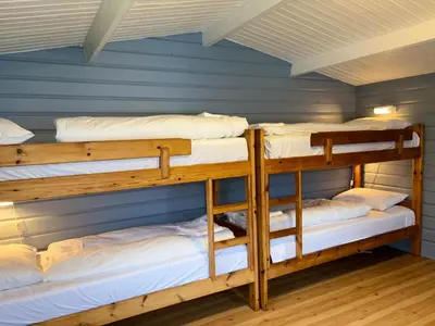 two bunk beds in a room with a blue wall at Winjum Cabin Aurland Stegastein in Aurland