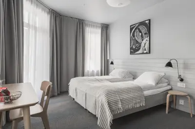 a hotel room with a bed and a table and a table sidx sidx at Heimen Hotel in Bergen