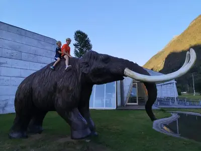 two children sitting on top of an elephant statue at Sogndal ski- and mountain cabin in Sogndal
