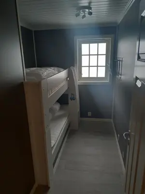 a small room with a bunk bed and a window at Sogndal ski- and mountain cabin in Sogndal