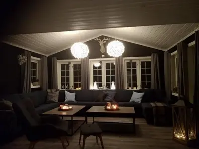 a living room with a couch and a table at Sogndal ski- and mountain cabin in Sogndal