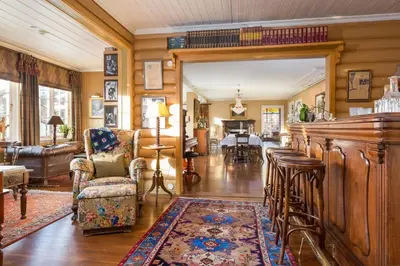 a living room with a bar and a dining room at Geilo Mountain Lodge in Geilo