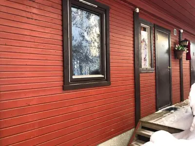 a red house with a window on the side of it at Rena HOSTEL EINARA in Rena