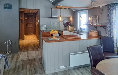 a kitchen with a counter and a table in a room at Four-Bedroom Holiday Home In Rendalen in Rendalen