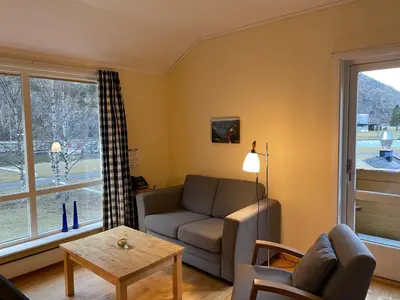 a living room with a couch and a table at Lærdal Ferie- og Fritidspark in Lærdalsøyri