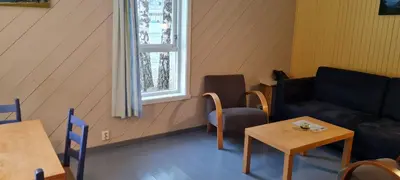 a living room with a couch and a table and a window at Lærdal Ferie- og Fritidspark in Lærdalsøyri