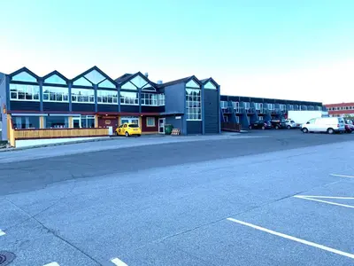 an empty parking lot in front of a building at Husnes Sentrum Hotell in Husnes