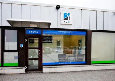 a store front with the entrance to a car dealership at Husnes Sentrum Hotell in Husnes