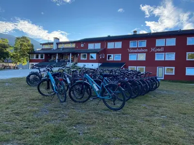 a group of bikes parked in front of a red building at Vatnahalsen Høyfjellshotell in Myrdal