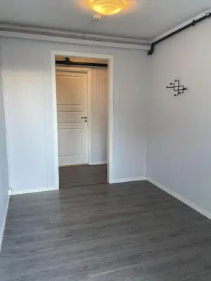 an empty room with white walls and a door at Hardangerpark AS in Kinsarvik