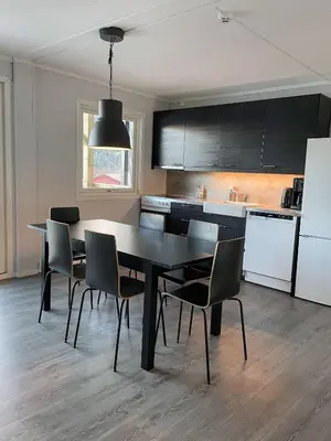 a kitchen with a dining room table and chairs at Hardangerpark AS in Kinsarvik