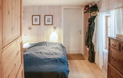 a bedroom with a bed in the corner of a room at 4 Bedroom Stunning Home In Rendalen in Rendalen