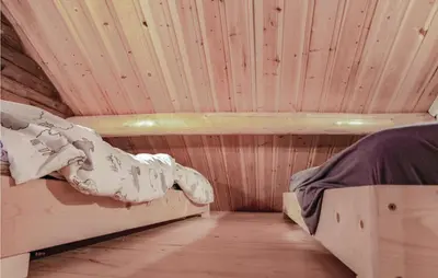 a room with two bunk beds in a wooden cabin at 4 Bedroom Stunning Home In Rendalen in Rendalen