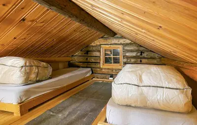 a bedroom with two beds in a log cabin at 4 Bedroom Stunning Home In Rendalen in Rendalen