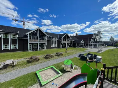 a house with a yard with a pool at Trysilfjell Apartment Hotel in Trysil