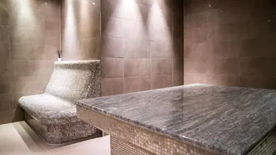 a bathroom with a stone table and a chair at Scandic Seilet Hotel in Molde