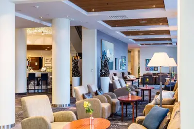 a lobby of a hotel with couches and tables at Scandic Seilet Hotel in Molde