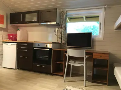 a small kitchen with a desk and a television at Bergen Camping Park in Bergen