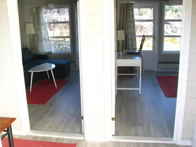 an open door into a living room with a desk at Bergen Camping Park in Bergen