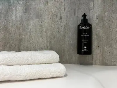 a pile of towels next to a bottle of soap at Frichs Ekspress Åndalsnes in Åndalsnes