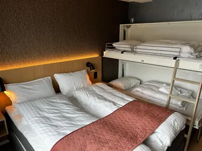 a room with two bunk beds and a bed at Frichs Ekspress Åndalsnes in Åndalsnes