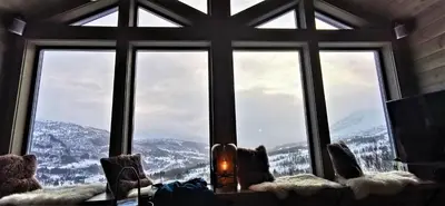 a window with a view of a snowy mountain at Timblalodgen in Sogndal