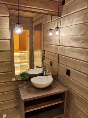 a bathroom with two sinks and a mirror at Timblalodgen in Sogndal