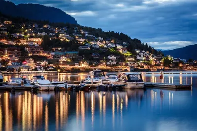 a group of boats docked at a marina at night at Timblalodgen in Sogndal