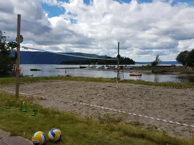 a volleyball court with two volleyball balls on the grass at Utvika Camping in Nes