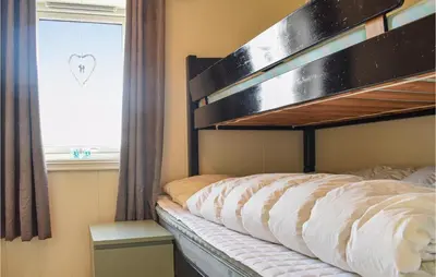 a bedroom with a bunk bed with a window at Gorgeous Home In Torangsvåg With Wifi in Skår