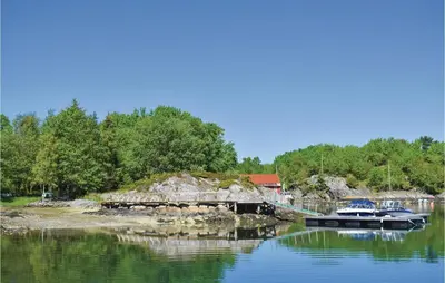 two boats docked at a dock on a lake at Gorgeous Home In Torangsvåg With Wifi in Skår