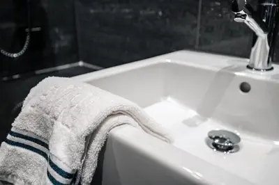 a towel hanging on the edge of a bathroom sink at Fýri Resort in Hemsedal