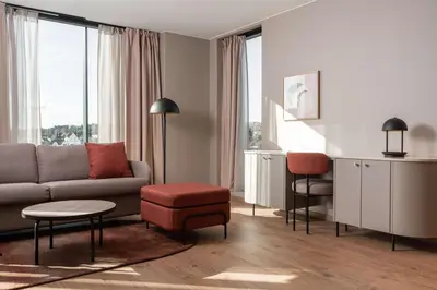 a living room with a couch and a chair at Scandic Hamar in Hamar
