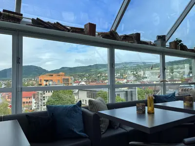 a room with a table and a large window at Aksjemøllen - by Classic Norway Hotels in Lillehammer