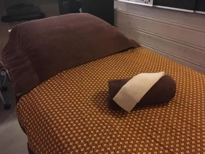 a bed with a pillow on top of it at Osensjøen Camping in Valmen