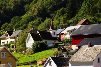a small town with houses and a mountain at Visit Undredal in Undredal