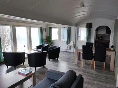 a living room with a couch and a table and chairs at Visit Undredal in Undredal