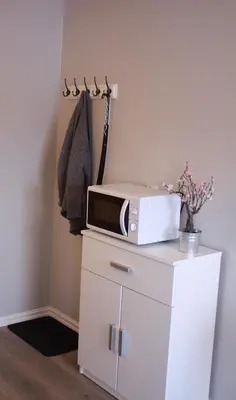 a microwave sitting on top of a white cabinet at Studioleilighet i Haukedalen in Holsen