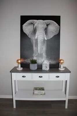a black and white photo of an elephant standing on a dresser at Studioleilighet i Haukedalen in Holsen