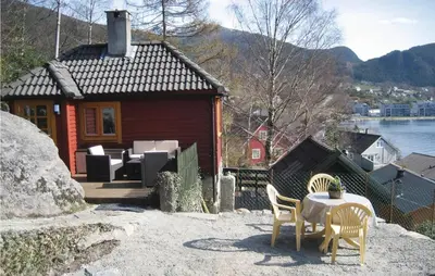 a small house with a table and chairs in front of it at Nice Home In Valen With Wifi in Valen