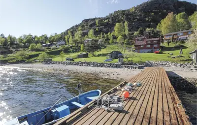a boat is docked at a dock on the water at Nice Home In Valen With Wifi in Valen