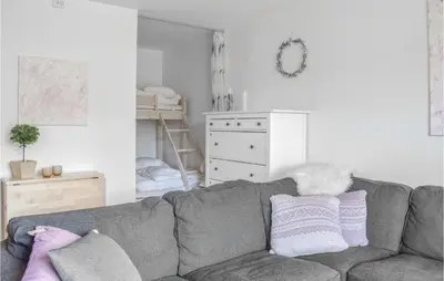 a living room with a gray couch with pillows at Stunning Apartment In Vossestrand in Vossestrand